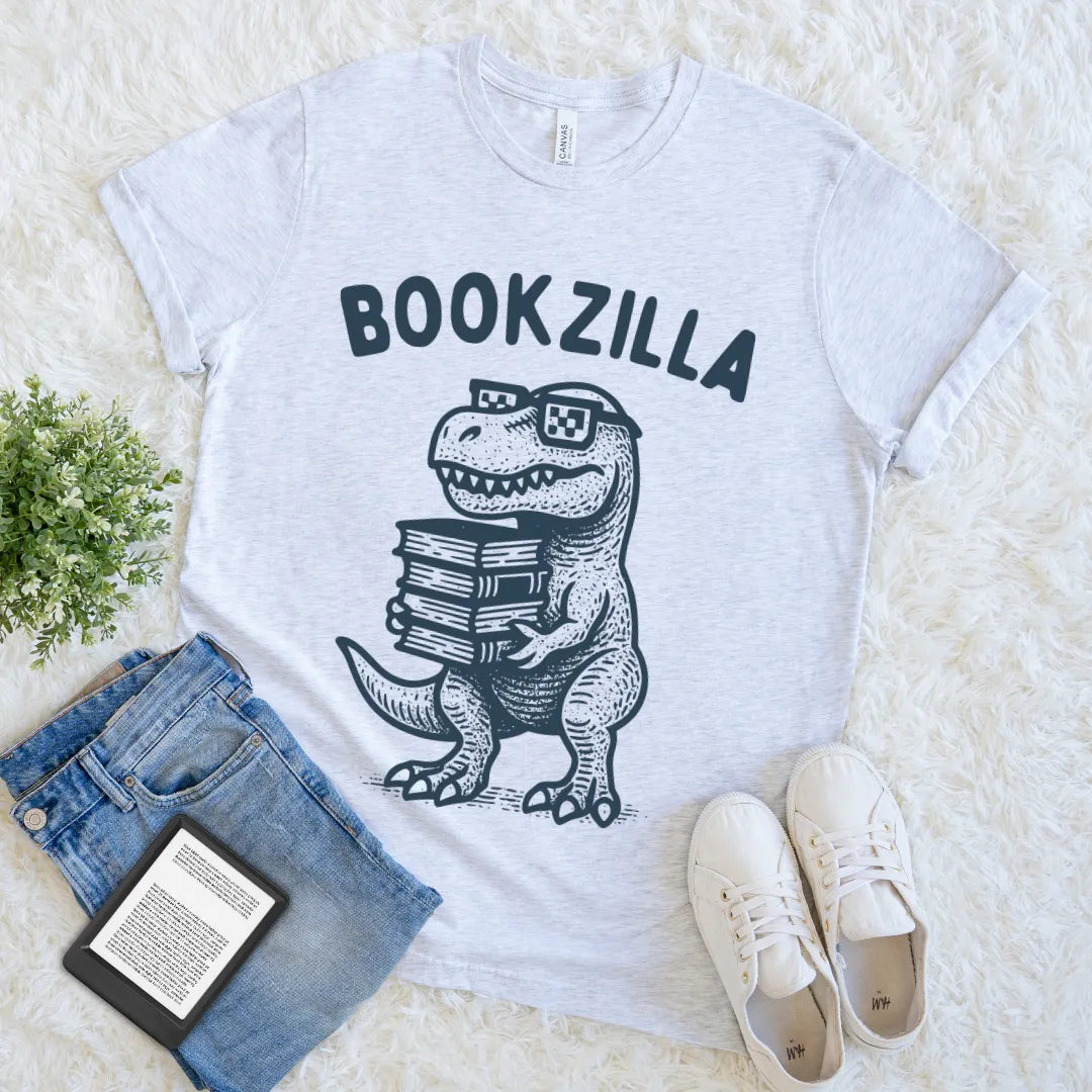 Grey Bookzilla graphic tee with dinosaur and book stack design