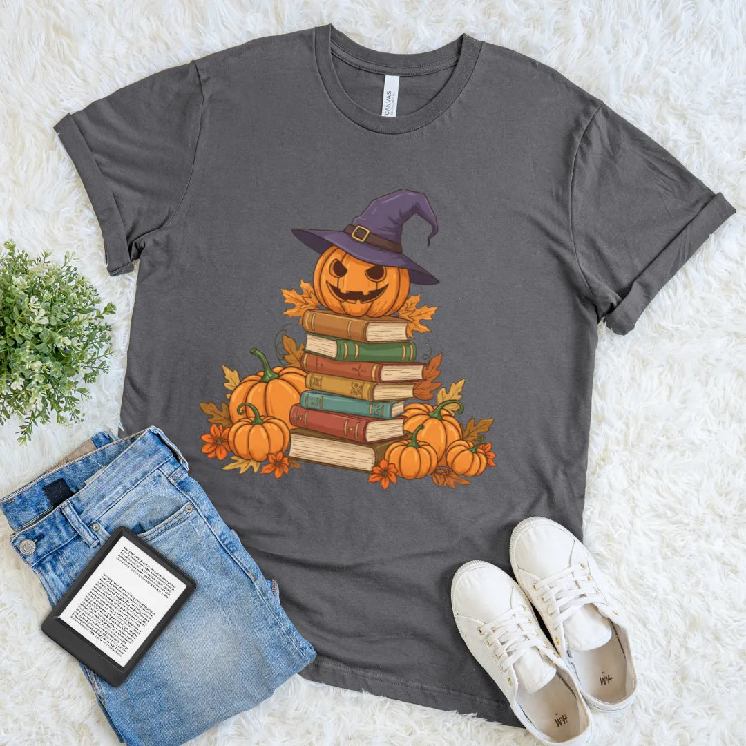 Grey halloween-themed book lover tee with jack-o-lantern in witch hat and autumn leaves