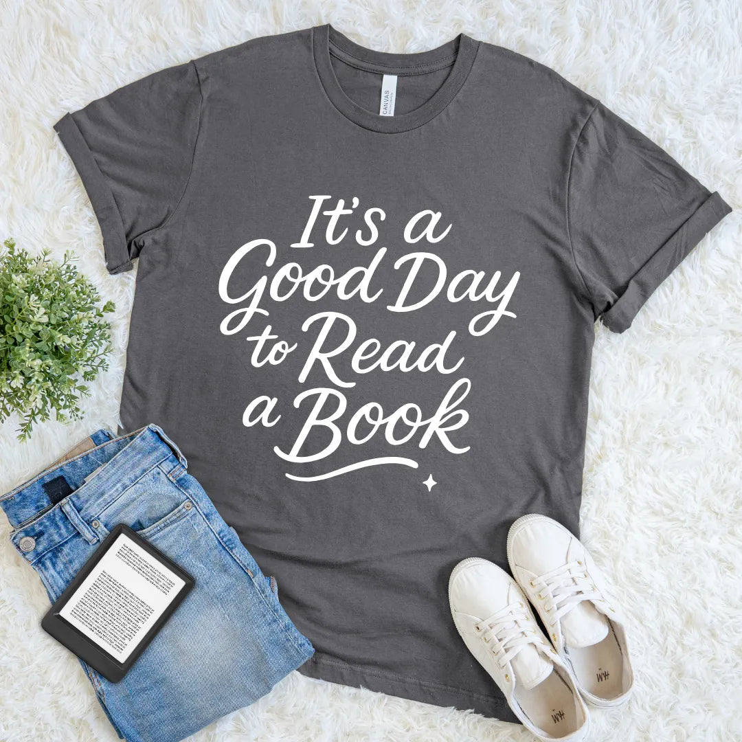 Gray t-shirt with 'It's a Good Day to Read a Book' text, paired with jeans and sneakers on a light background
