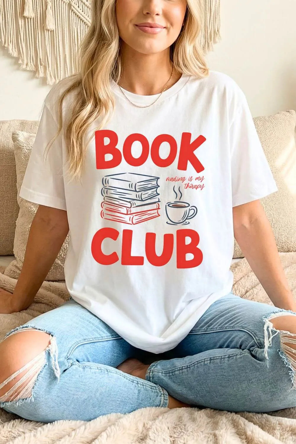 woman wearing a white t-shirt with 'Book Club' text and graphics styled with jeans for relaxed reading outfit