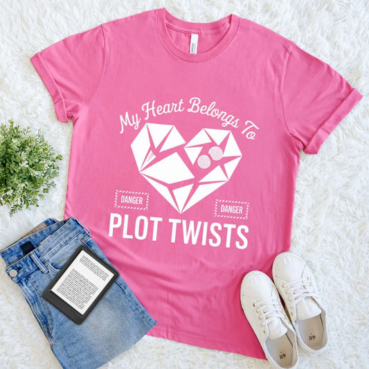 bright pink book lover T-shirt with white broken heart and “My Heart Belongs to Plot Twists” anti-valentine text