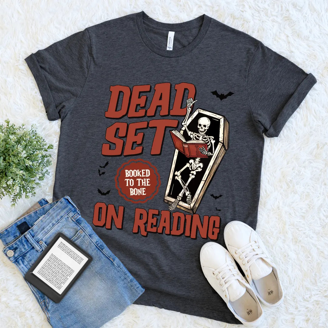 grey t-shirt featuring skeleton in coffin and spooky bats