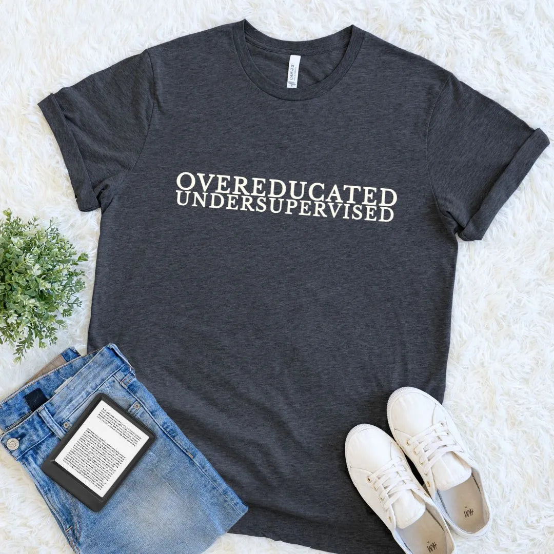 Soft bookish T-shirt featuring Overeducated Undersupervised literary quote on dark grey heather fabric