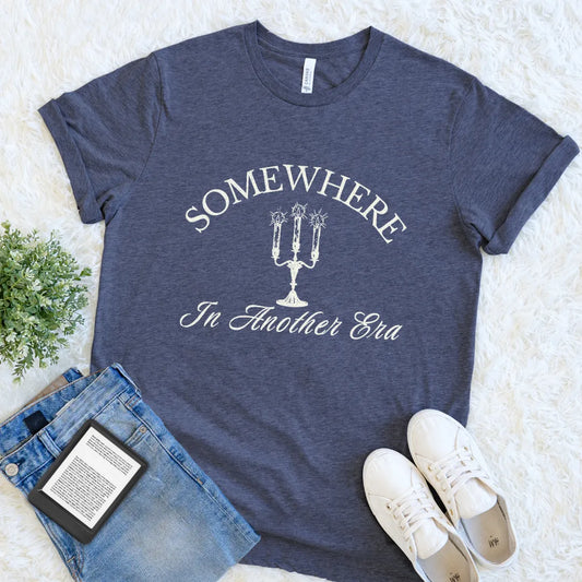 Cozy book lover T-shirt inspired by classic literature and antique aesthetics featuring Somewhere In Another Era typography on heather navy fabric