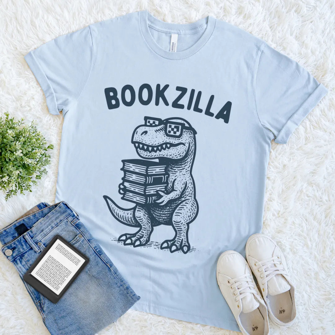 Light blue playful reader shirt with nerdy dino character and books