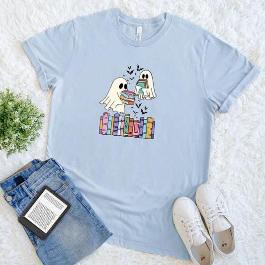 Playful ghostly tee design with colorful books and flying bats