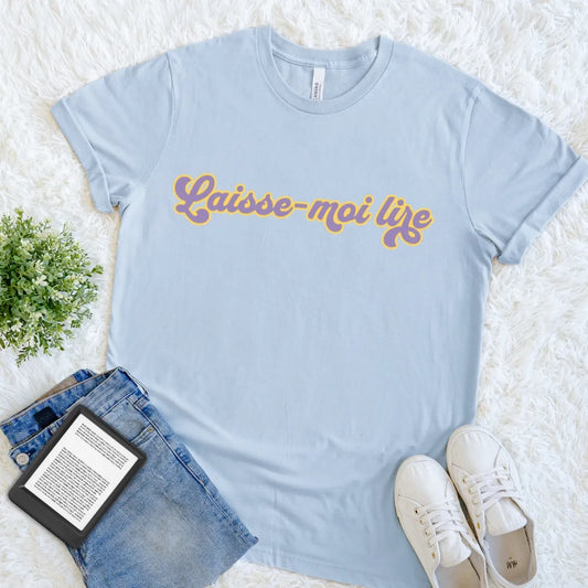 Light Blue Laisse-Moi Lire book lover T-shirt featuring colorful 1970s-inspired French typography, a cheerful retro reader tee meaning let me read.