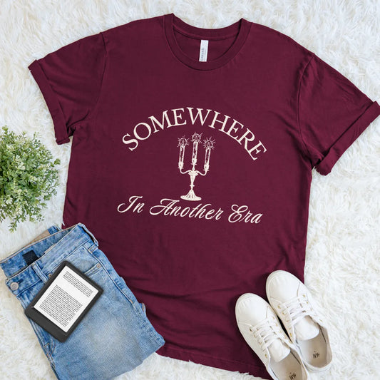 Dark academia reader tee with romantic vintage typography design 'Somewhere In Another Era' on maroon red cotton