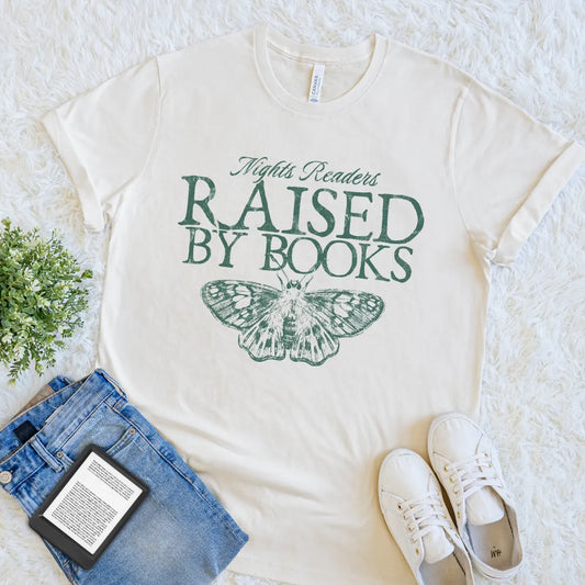 Cream book lover T-shirt with Raised by Books text and vintage moth illustration