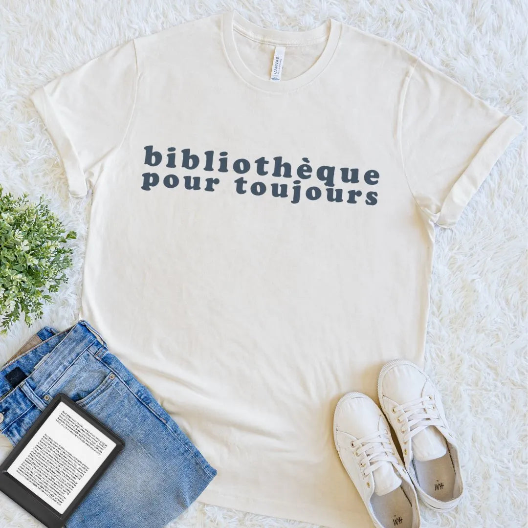 Natural cream literary T-shirt with dark Bibliothèque Pour Toujours text in a clean flat lay for devoted library readers