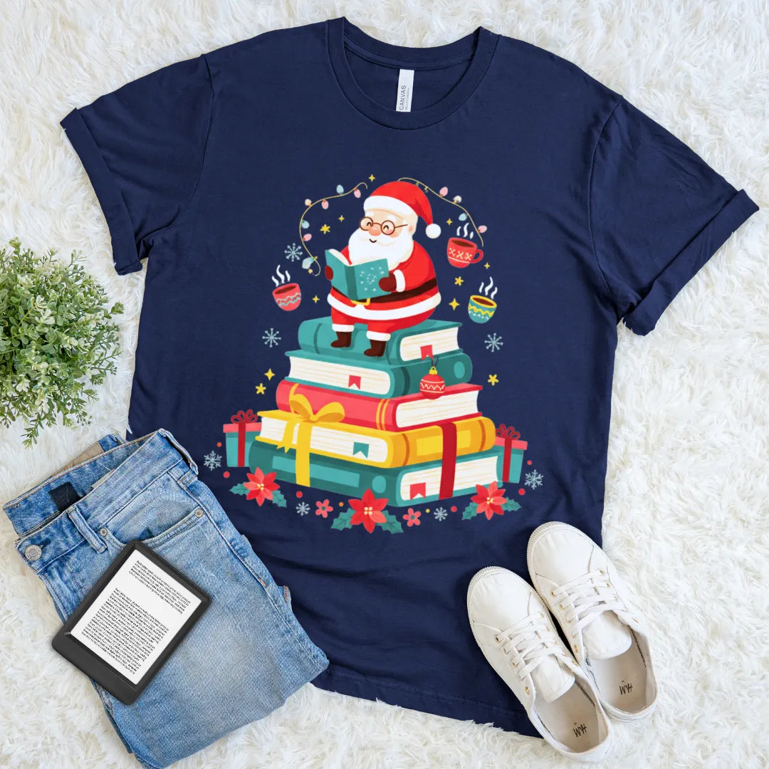 Holiday tee featuring gifts, books, and Santa holding a book