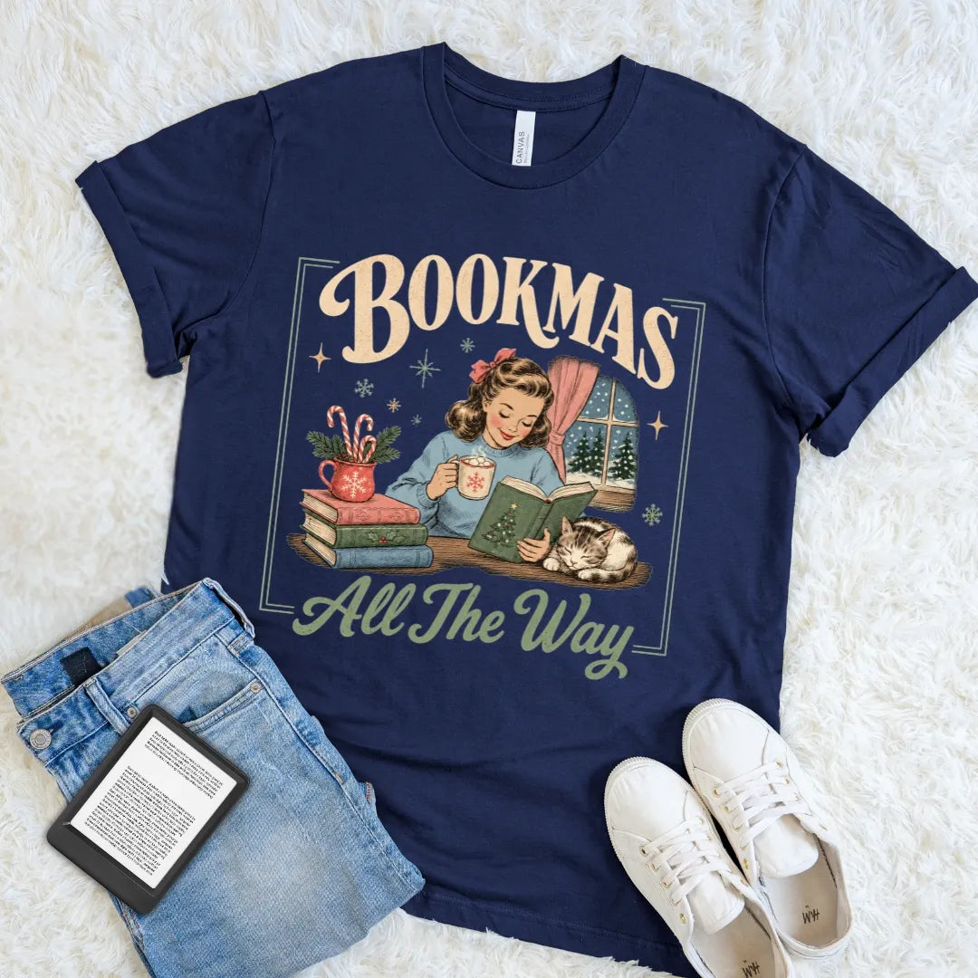 Navy Bookmas shirt featuring a nostalgic holiday reading scene framed by snowflakes, candy canes, and retro typography.