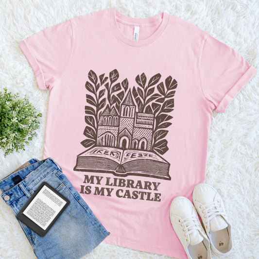 Cozy literary shirt with storybook castle and leaves illustration on pink cotton
