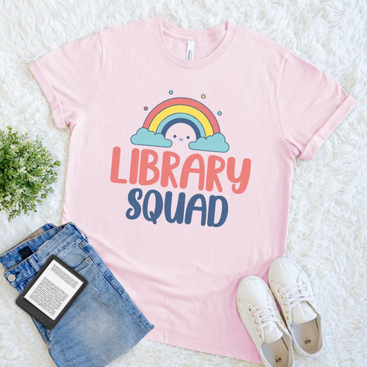 Pink bookish tee featuring pastel rainbow and happy cloud