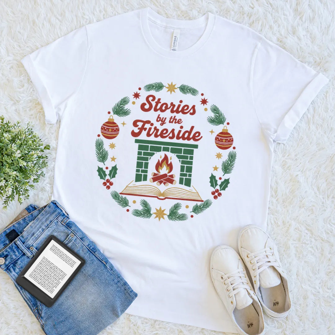 White bookish tee with a fireplace and open book surrounded by festive greenery