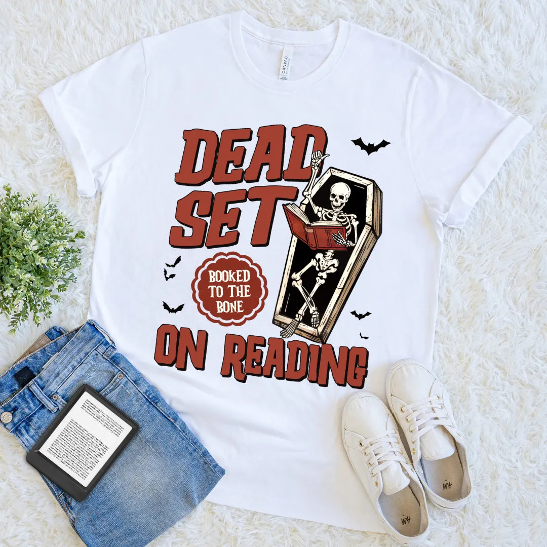 white t-shirt featuring skeleton in coffin and spooky bats
