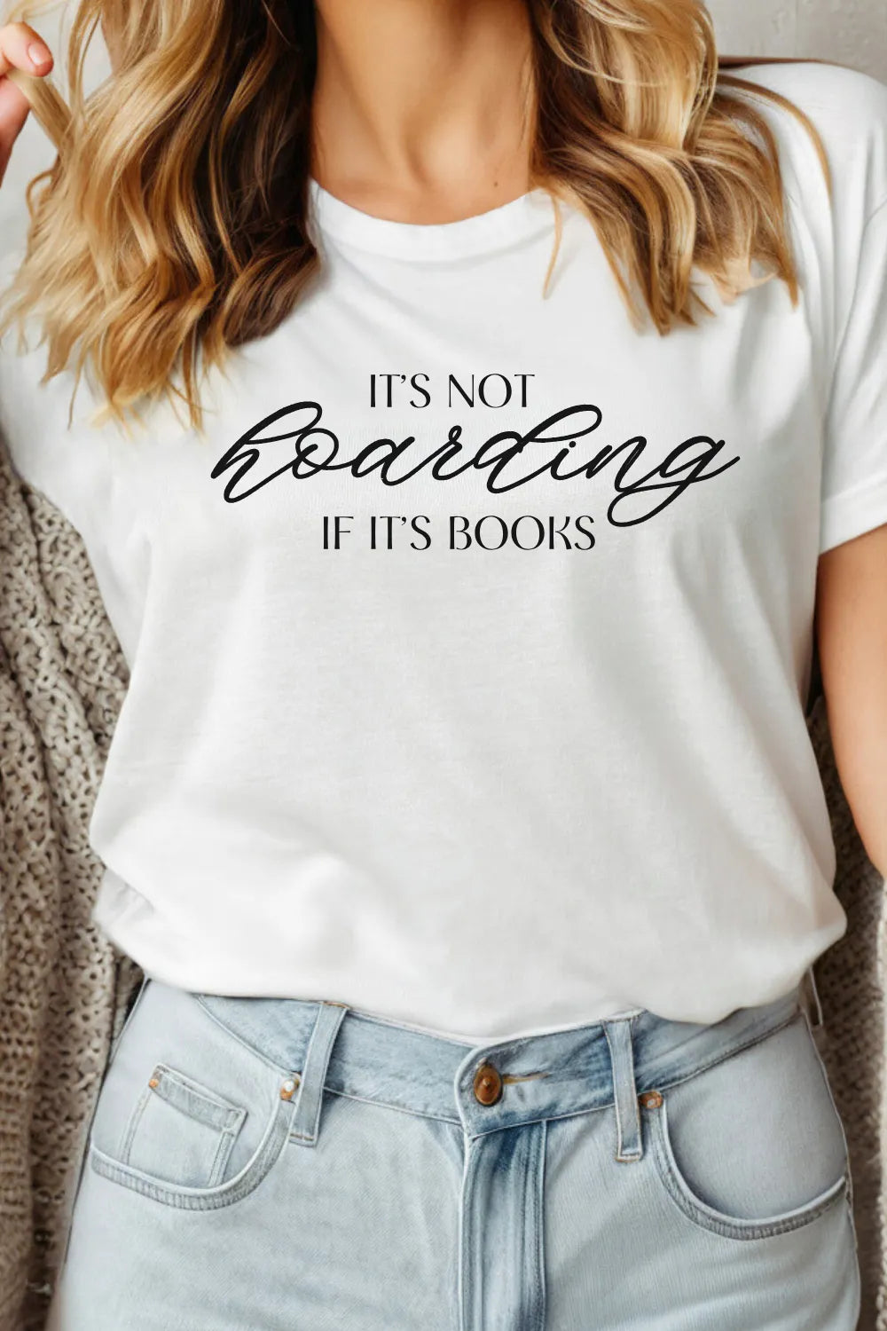 woman wearing white minimalist T-shirt with elegant black script reading “It’s not hoarding if it’s books”