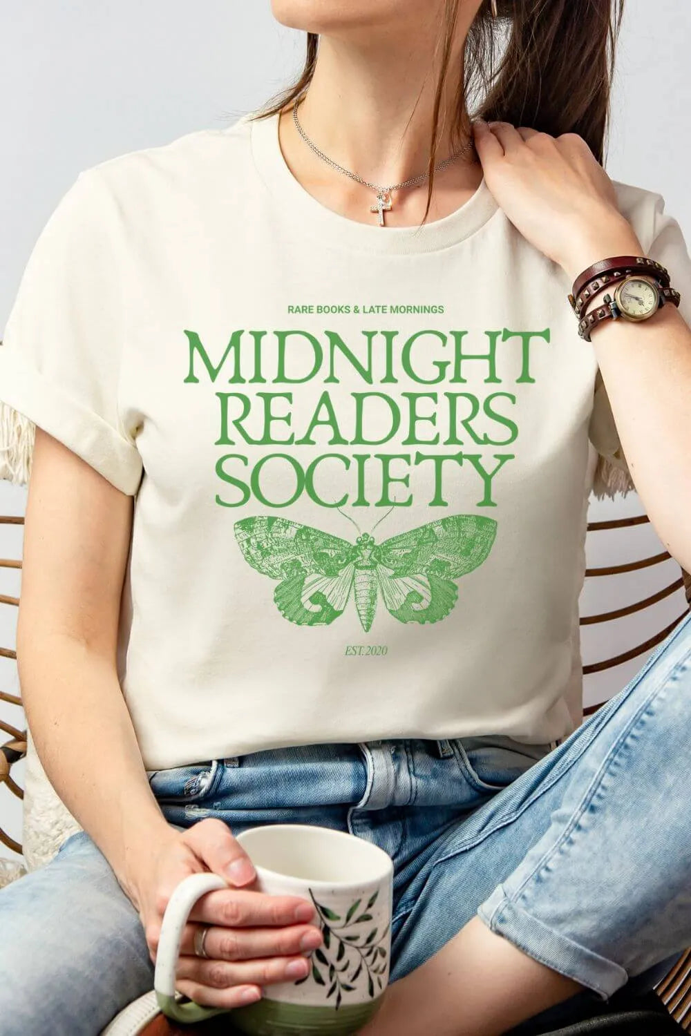 woman wearing soft cotton cream t-shirt with green moth design and "midnight readers society" dark academia quote