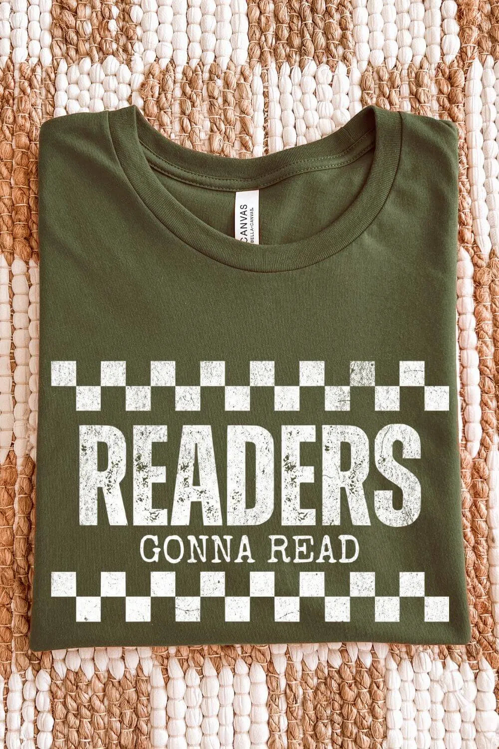 folded soft cotton military green t-shirt with vintage distressed checkerboard design and "readers gonna read" quote