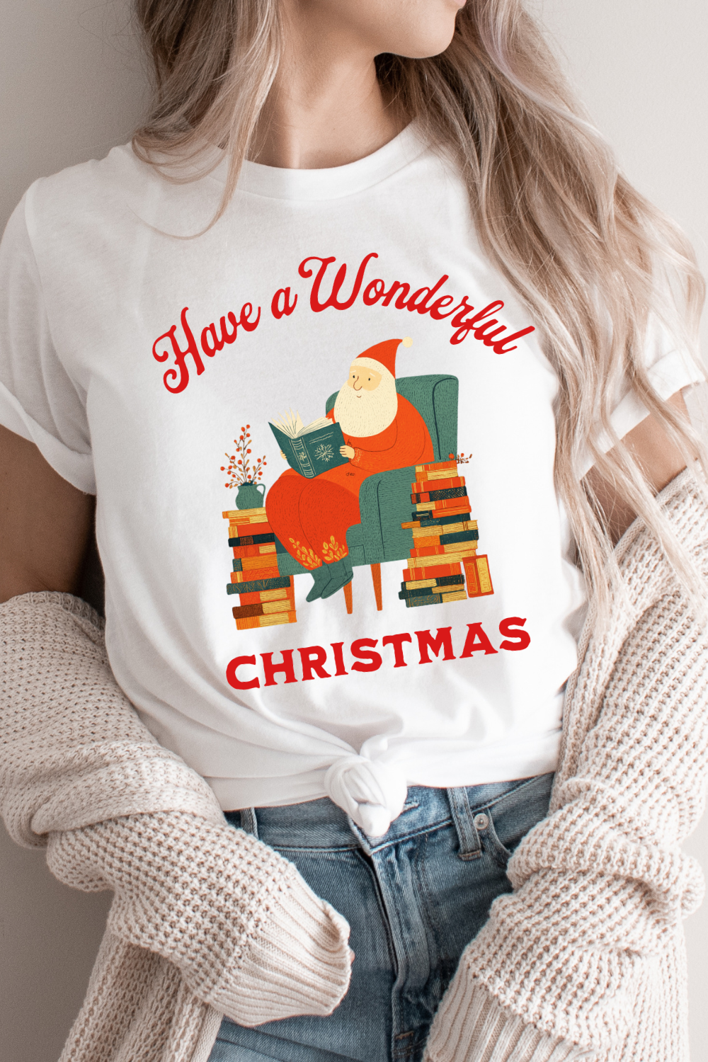 woman wearing White T-shirt outfit featuring  Santa reading in green armchair and “Have a Wonderful Christmas” text