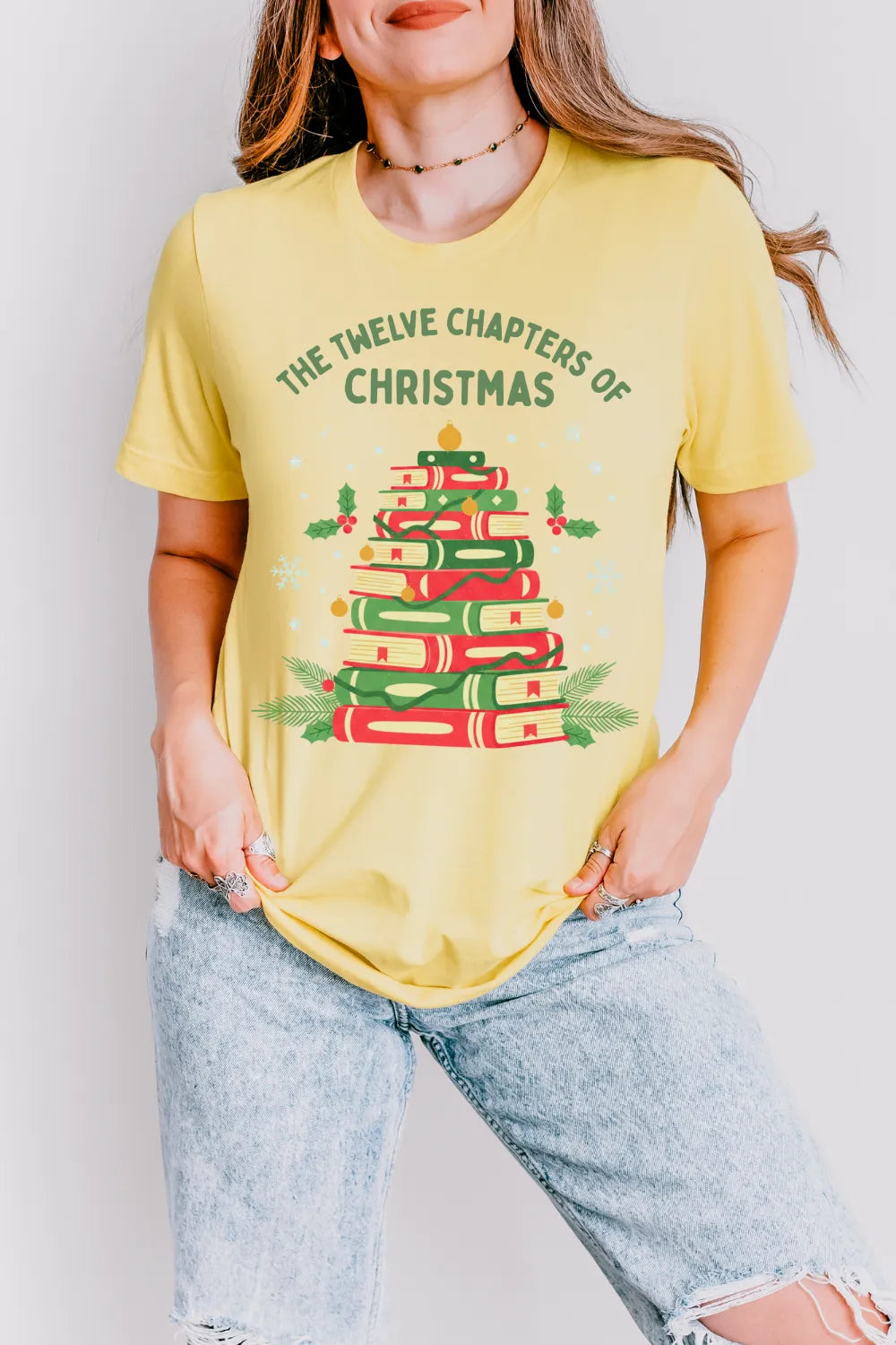 Woman wearing yellow Holiday vintage  t-shirt with red and green stacked books