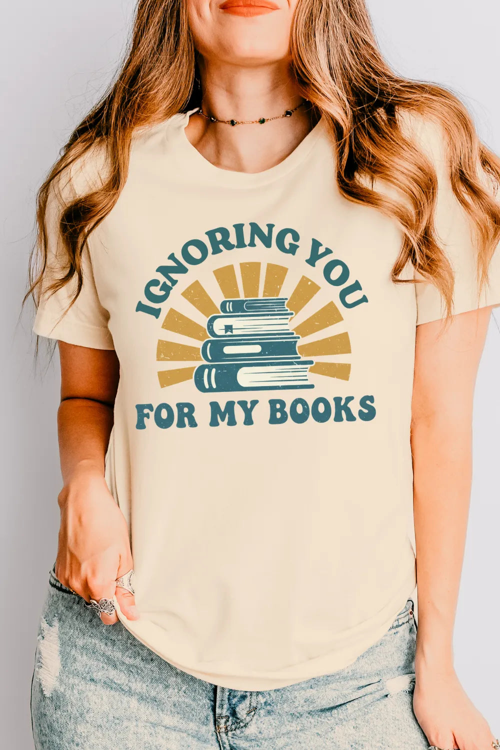 woman wearing Soft cotton bookish T-shirt with sarcastic literary vibe and “Ignoring You for My Books” text