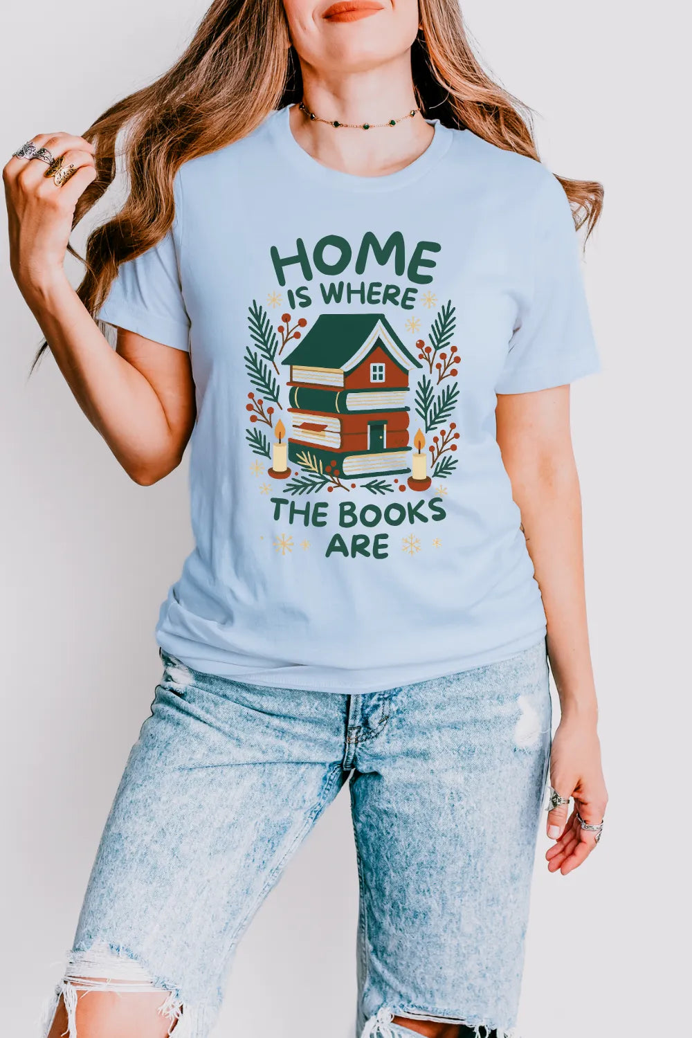 woman wearing light blue vintage t shirt featuring home built from novels and “Home is where the books are” text