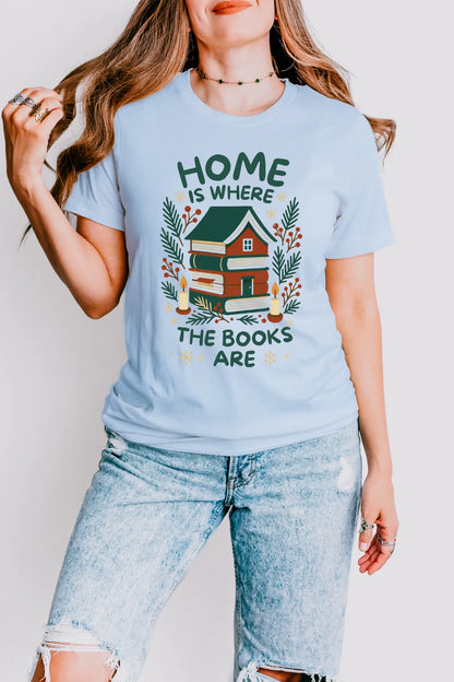 woman wearing light blue vintage t shirt featuring home built from novels and “Home is where the books are” text