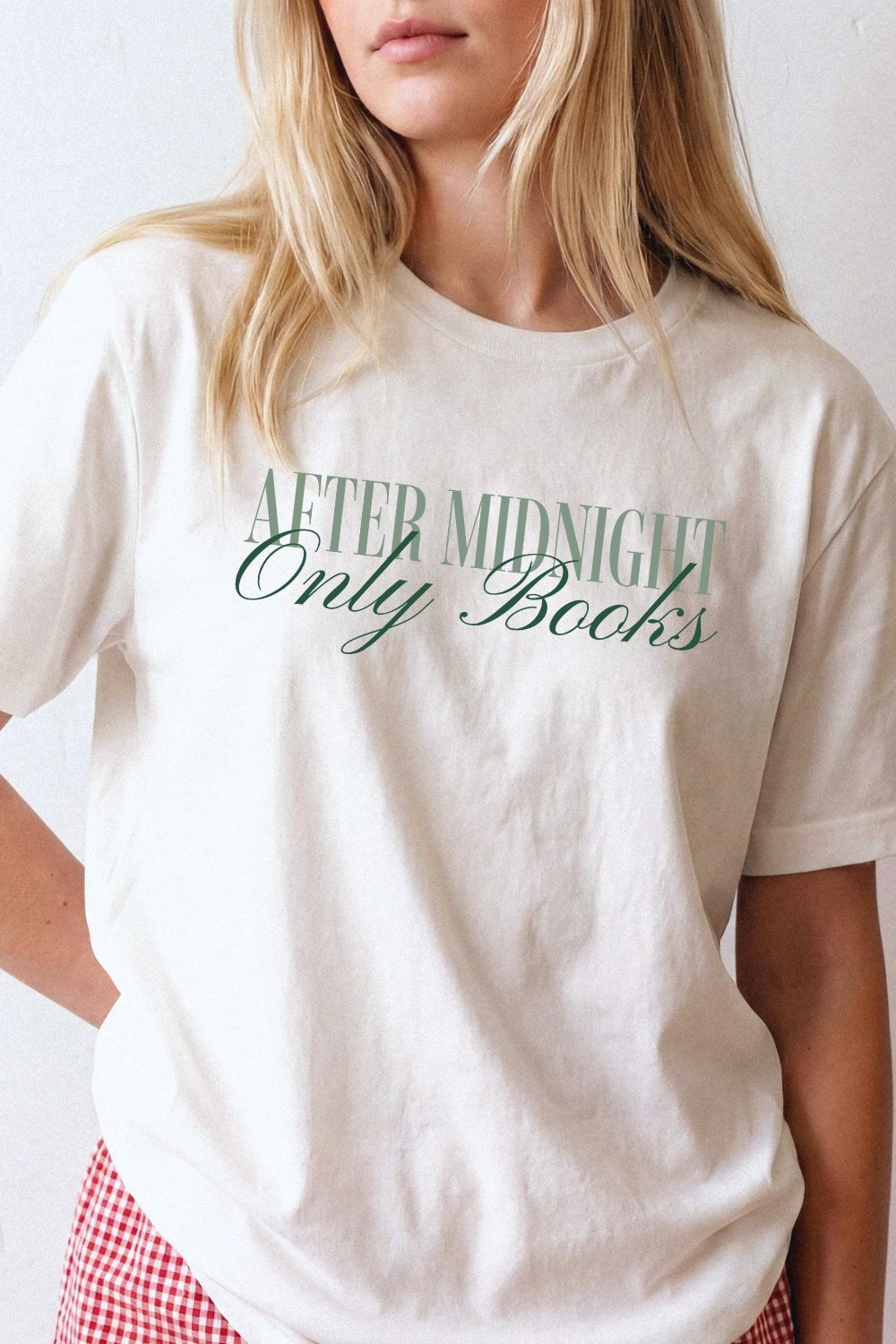 Woman wearing cream bookish t-shirt with “After Midnight Only Books” text, minimalist typography, styled as soft aesthetic outfit for night reading lovers