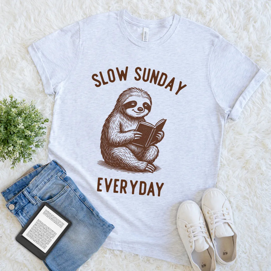 flat lay of ash grey introvert book lover  t-shirt, featuring cute sloth design and Slow Sunday Every Day text