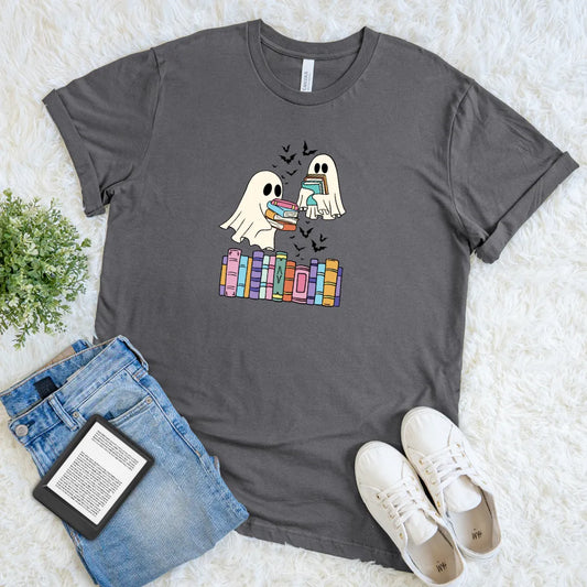 Gray t-shirt with two cartoon ghosts holding books above a stack of pastel-colored bookshelf