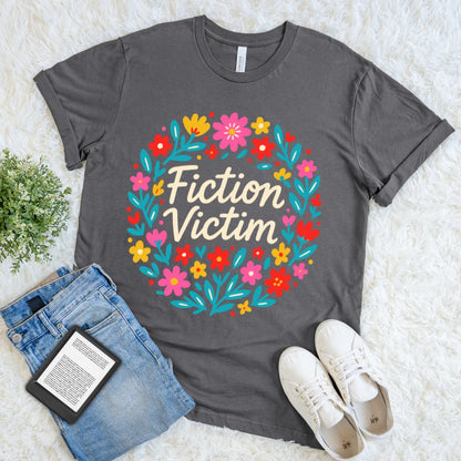 Grey graphic t-shirt for readers with floral design and funny bookish quote "Fiction victim"