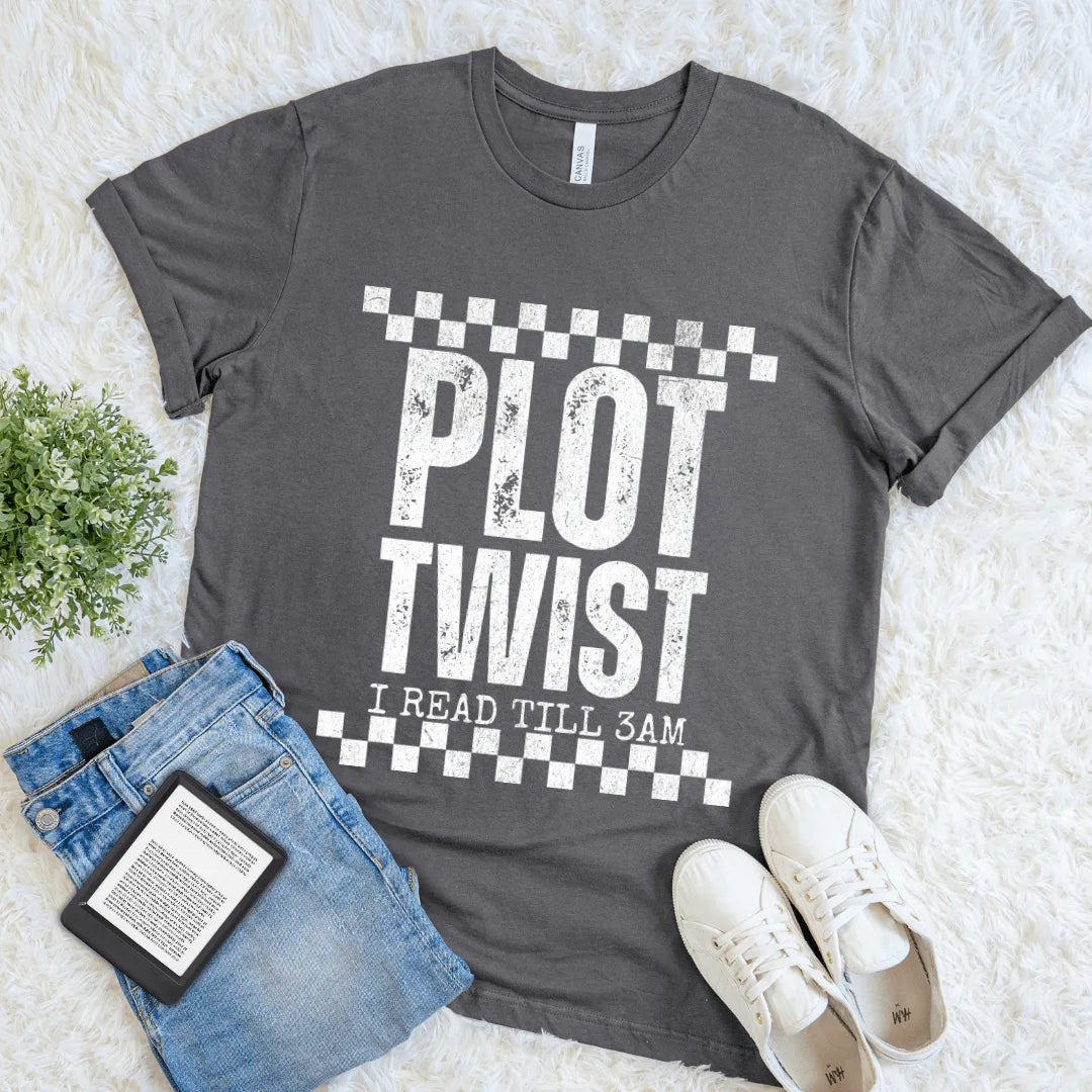 Flat lay of gray T-shirt with distressed white text “Plot Twist – I Read Till 3AM”