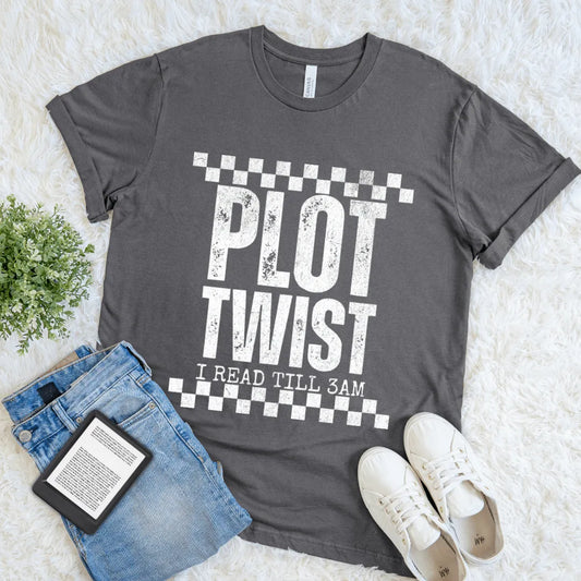 Flat lay of gray T-shirt with distressed white text “Plot Twist – I Read Till 3AM”