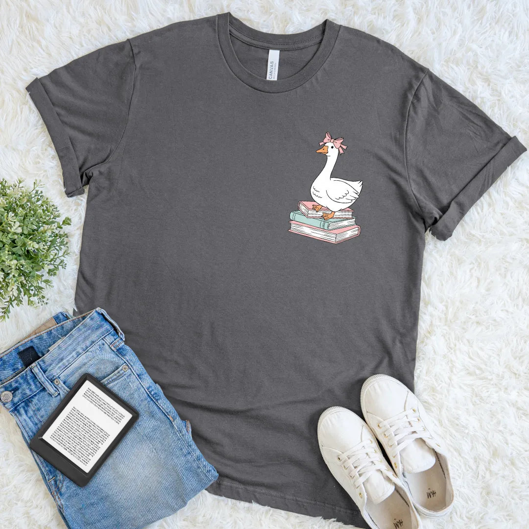 Gray t-shirt with a silly goose graphic on books, paired with jeans and sneakers on a light background