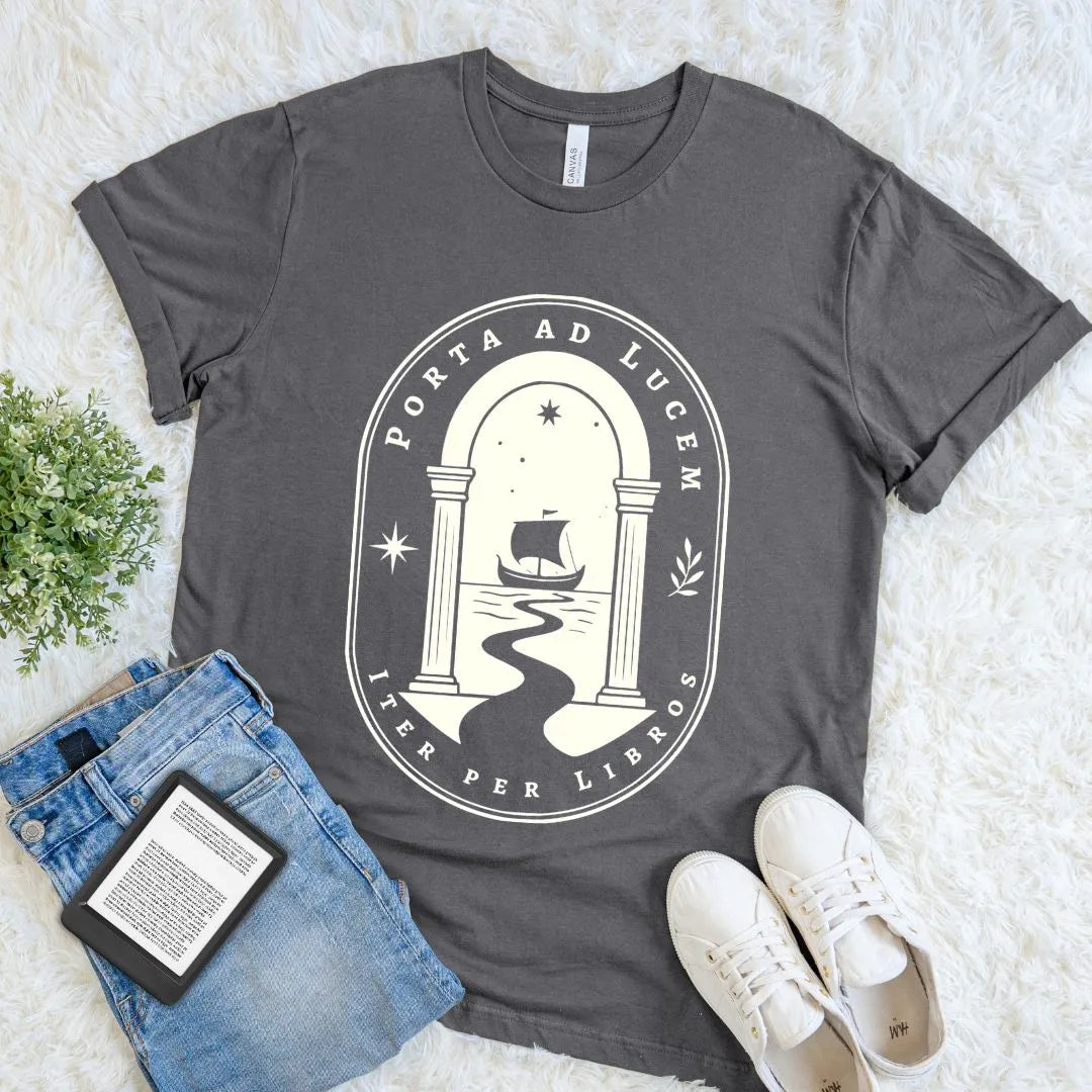Asphalt Porta ad Lucem reader T-shirt with ivory archway and sailing ship graphic, a dark academia bookish shirt inspired by books, libraries, and literary journeys.