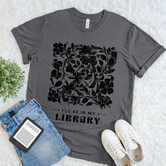 Book lover gray t-shirt with black floral design and text 'I'll be in my library' on a light background