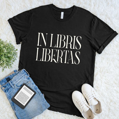 Close up of refined serif Latin typography “In Libris Libertas” screen printed on black premium cotton dark academia graphic tee