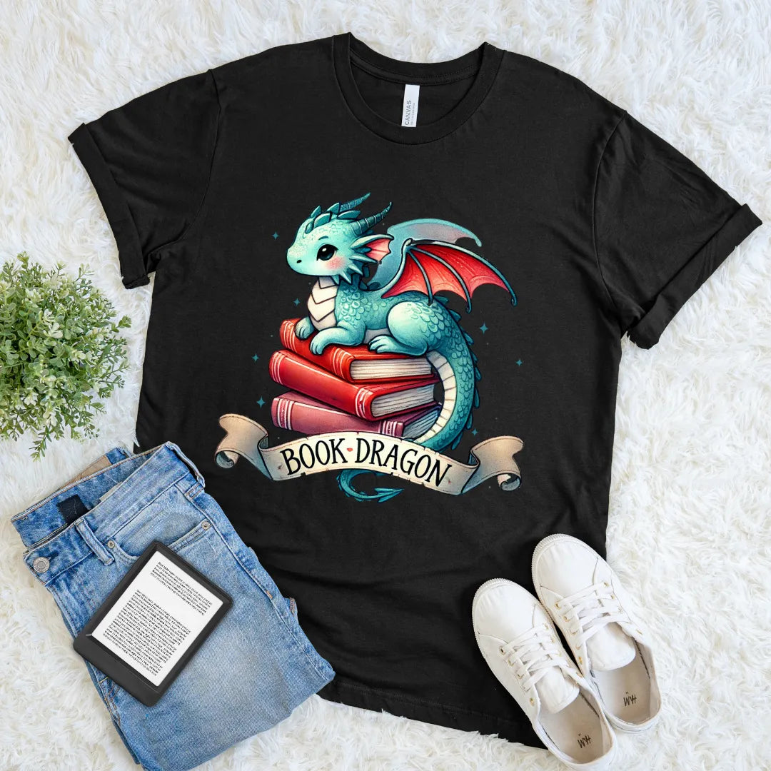 Black t-shirt with a colorful dragon design on books, accompanied by jeans and sneakers on a light background.