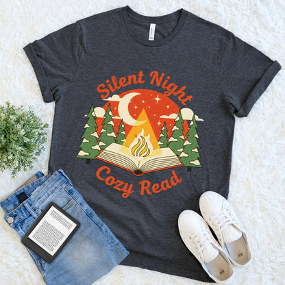 Nighttime reading design with moon, stars, and snowy trees on grey heather t-shirt