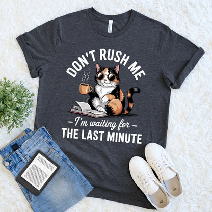 flat lay of funny reading t-shirt with cool calico cat reading book  and tea mug