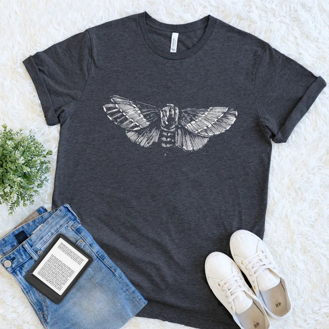 Dark gray t-shirt with moth design, paired with jeans and sneakers on a light background