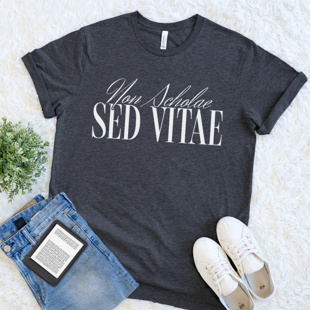 dark academia  t-shirt with 'Non Scholae Sed Vitae' text, paired with jeans and sneakers on a light background for intellectual aesthetic outfit