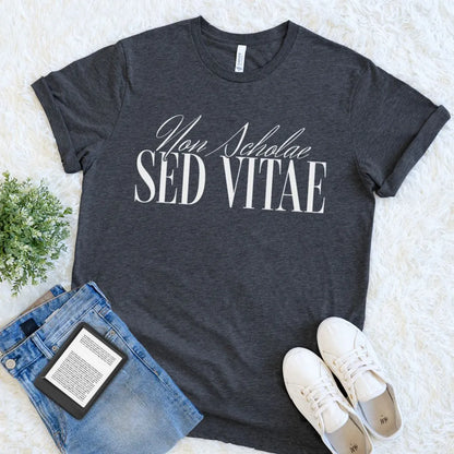 dark academia  t-shirt with 'Non Scholae Sed Vitae' text, paired with jeans and sneakers on a light background for intellectual aesthetic outfit