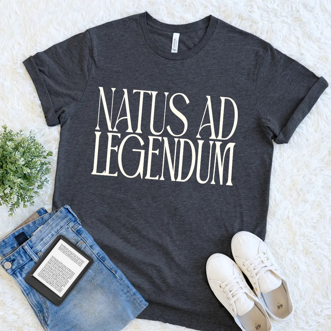 Charcoal grey heather literary T-shirt featuring a minimalist Latin reading motto Natus ad Legendum typography meaning born to read in vintage-inspired type.