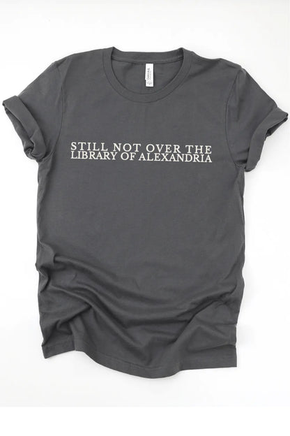 flat lay gray literary t-shirt with “Still Not Over the Library of Alexandria” typography in minimalist serif lettering for librarian aesthetic outfits