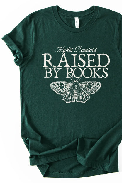Forest green dark academia graphic t-shirt with “Raised By Books” typography and vintage moth illustration, green academia aesthetic