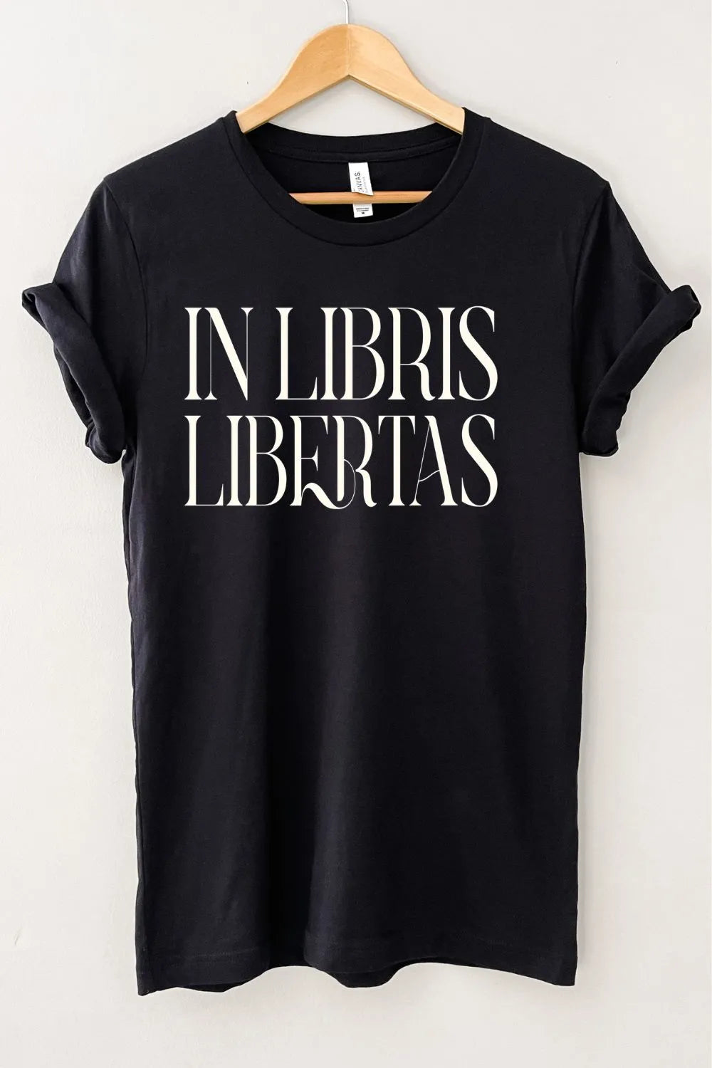 Black dark academia aesthetic graphic t-shirt featuring elegant “In Libris Libertas” Latin typography for book lovers