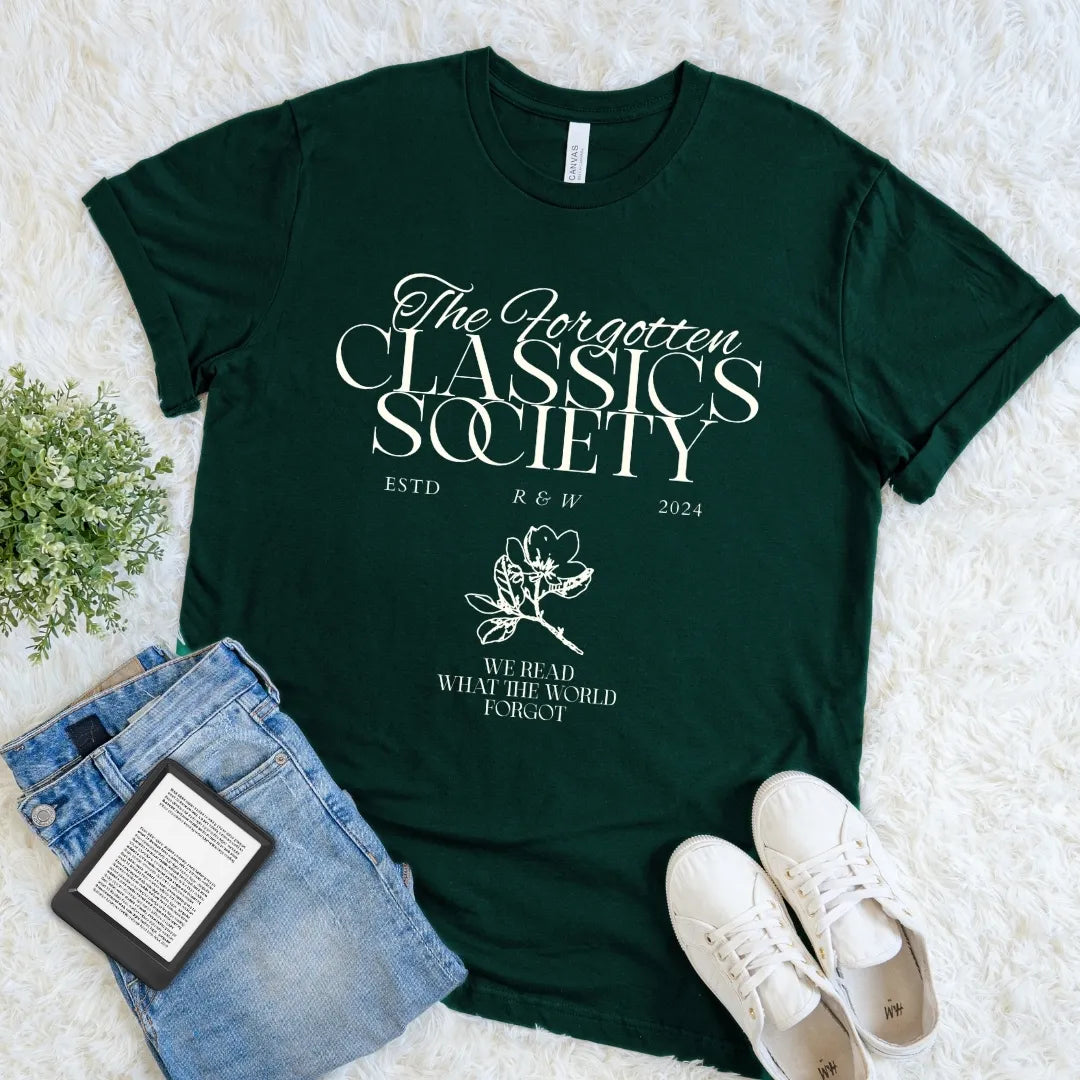 Forest green Forgotten Classics Society literary T-shirt with vintage cream lettering, delicate floral ornament, and “We Read What the World Forgot,” a classic literature shirt for devoted readers.