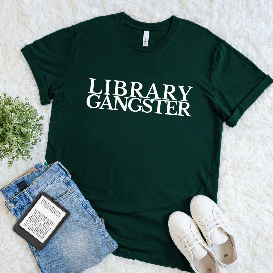 Reader aesthetic T-shirt celebrating books, libraries, and reading culture with bold serif typography on forest green cotton